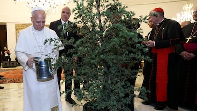 The pontiff, watering a tree next to President Aoun, was making his first foreign trip on a six-day visit to Turkey and Lebanon. AFP