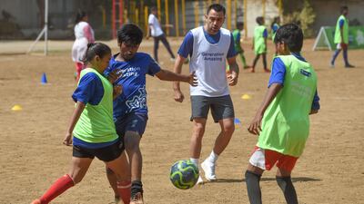Former Spain international midfielder Xavi looks on as he plays with Indian children a football game in Mumbai on March 18, 2019. Xavi is the first global ambassador for the Generation Amazing programme. All pictures by AFP