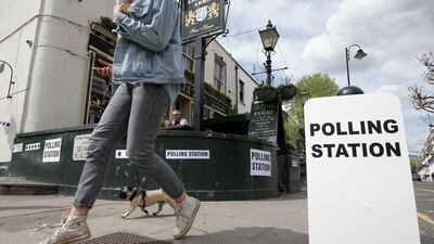 People enjoy a lunchtime drink in the sunshine outside the Anglesea Arms, which is acting as a polling station in the Borough of Kensington and Chelsea in London on May 3, 2018, as local council elections take place across the capital.