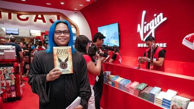 Robert Maramag picks up a copy of Harry Potter and the Cursed Child at Virgin Megastore at the Mall of the Emirates. Victor Besa for The National