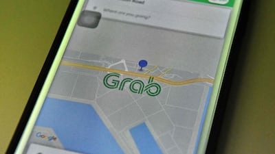 The Grab booking application seen on a smart phone in Singapore. Singapore-based ride-hailing firm Grab has bought US rival Uber's business in South East Asia. Roslan Rahman/AFP