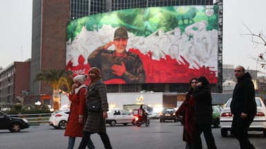 People walk on a street as protests erupt over the collapse of the currency's value in Tehran. Reuters