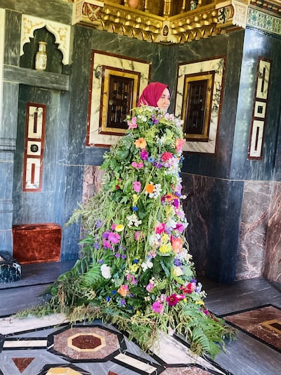 The enormous living cape woven from the broom, meadowsweet and oak flowers used to create Blodeuwedd in The Mabinogion, and worn by Hanan Issa in the Arab Room at Cardiff Castle. Photo: Hanan Issa
