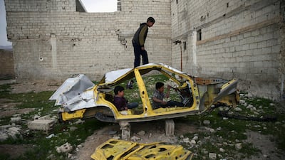 Boys play on a wrecked car in the rebel held besieged Douma neighbourhood of Damascus, Syria. Bassam Khabieh / Reuters