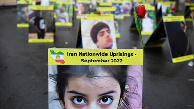 Placards with portraits of the victims of Iran's repression displayed near the French National Assembly in Paris. AFP