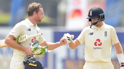 Jos Buttler, left, scored a fifty to lead England's reply alongside Joe Root.
