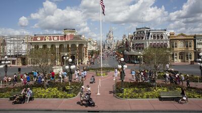 Visitors enter the Walt Disney Magic Kingdom park in Orlando, Florida. Bahrain's Investcorp is investing in sites in Orlando and Arizona and others in the US. David Ryder/Bloomberg