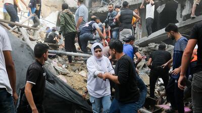 A girl is assisted as Palestinians search for casualties after an Israeli strike on a house, in Rafa in the southern Gaza Strip. Reuters