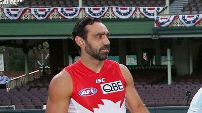 Sydney Swans player Adam Goodes holds an Australian Rules Football at the Sydney Cricket Ground. The continued booing of Goodes him when he plays for the Swans in the AFL had led to the point where he was thought to be considering retirement. Rick Rycroft / AP / March 19, 2014