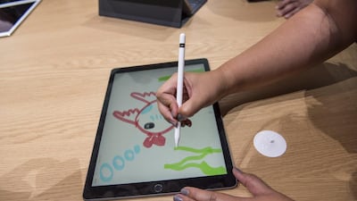 An attendees demonstrates the new Apple Pencil with the Apple iPad Pro tablet. David Paul Morris/ Bloomberg