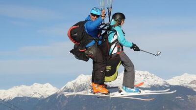 Mary Novakovich and her guide Franck from the company Here We Go Parapente paragliding above Valmorel. Adam Batterbee