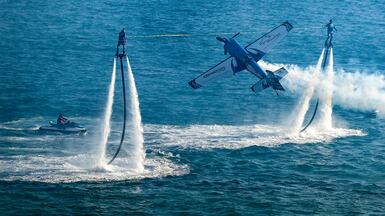 An aerobatic plane flies between waterjets in Santa Lucia Bay at the Acapulco Airshow, Mexico. EPA