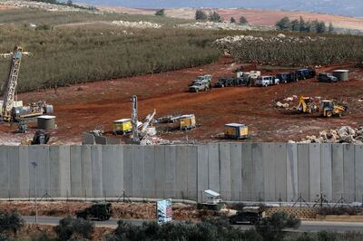 Across from the Lebanese village of Kfar Kila, Israeli machinery operate next to the concrete border wall. AFP