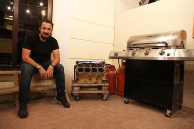 Christopher Dabell made a barbecue grill from a car engine. Photo: Pawan Singh / The National
