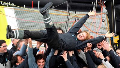 French skipper Francois Gabart celebrates with his team upon his arrival at the end of his solo around the world navigation in Brest, western France. Damien Meyer / AFP Photo