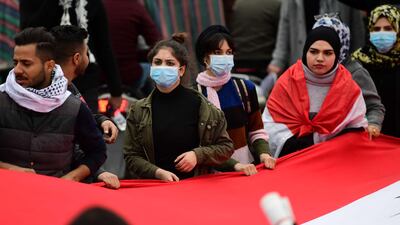 Iraqi university students carry the Iraqi national flag during a strike and protests in central Baghdad. EPA