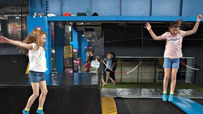 Young girls launch themselves in two of Bounce's 80 trampolines. Jeff Topping for The National