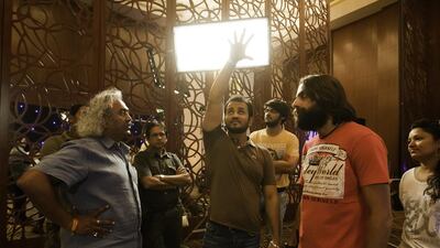 Director Mustafa Raj, centre, talks with his crew during the shooting of the movie Switchh, in Dubai. Jaime Puebla / The National