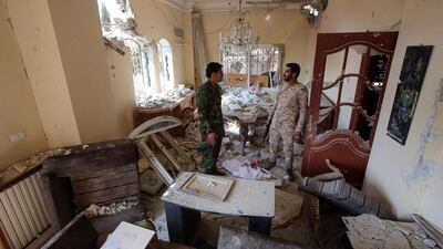 Syrian government forces inspecting a house in the Syrian city of Daraya on February 24, 2016, that was damaged in fighting. Youssef Karwashan/AFP
