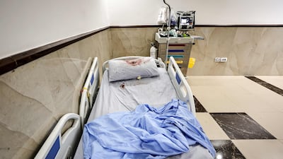 A bullet hole on a pillow covered in blood on a hospital bed at Ibn Sina Hospital. AFP