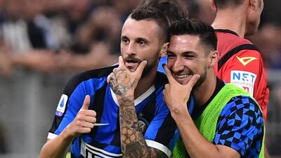 Inter Milan's Croatian defender Marcelo Brozovic celebrates with Matteo Politano after scoring. AFP