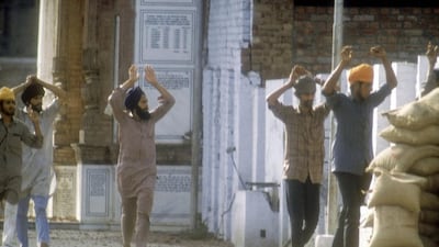 Suspected Sikh militants surrender after the Indian army assault on the Golden Temple in Amritsar in 1984. The India Today Group / Getty Images