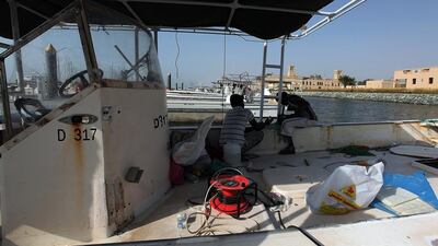 Fishermen maintaining their boat at the fishing harbour in Dubai. Satish Kumar / The National