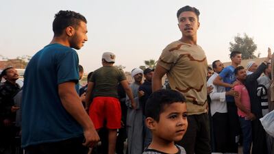 People wait to receive free food from volunteers from a charity which provides food to families in need and people who have lost their jobs due to the outbreak of the coronavirus disease in Cairo, Egypt April 27, 2020. Reuters