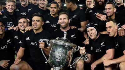 New Zealand captain Kieran Read, centre, holds the Bledisloe Cup after their win over Australia on Saturday. Marty Melville / AFP / August 27, 2016