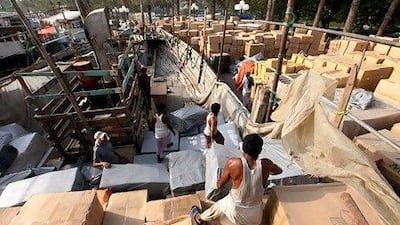 Workers load goods bound for Iran, one of Dubai's major trading partners, on dhows docked at Dubai Creek. Paulo Vecina / The National