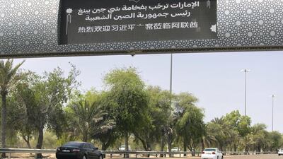 Signs on the Dubai to Abu Dhabi road welcome the Chinese president and his delegation to the UAE in Mandarin. Reem Mohammed / The National