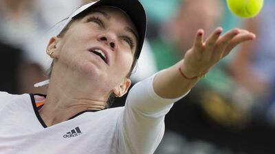 Simona Halep serves during her first round match at the Hertogenbosch Open on Tuesday. She had to retire with a shoulder injury during her second round match on Wednesday. Koen Syuk / EPA / June 17, 2014