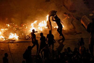 Lebanese protesters said they will remain in the streets despite the president's appeal for them to go home. AP