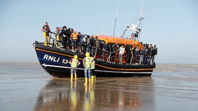 Migrants rescued from the English Channel by the Royal National Lifeboat Institution arrive at Dungeness. Reuters