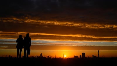 People view the sunrise over London as the second lockdown in England ends. Reuters