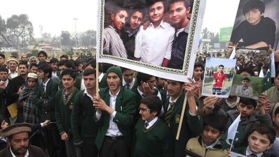 Students hold photographs of their schoolmates, who were killed in an attack by the Pakistani Taliban, during a protest demanding an investigation to bring the killers to justice in Peshawar on February 7, 2015. Fayaz Aziz/Reuters