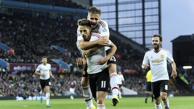 Manchester United's Adnan Januzaj, left, celebrates with teammate Luke Shaw after scoring during the English Premier League match against Aston Villa at Villa Park in Birmingham, Britain, on August 14, 2015. Hannah McKay / EPA