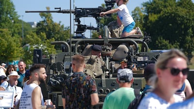 Visitors take part in the military picnic in Warsaw. EPA