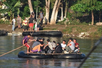 Honduran migrants taking part in a caravan heading to the US cross the Suchiate River between Guatemala and Mexico, on October 21, 2018. AFP