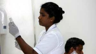 A nurse at Jebel Ali Hospital's Corporate Clinic in Dubai. At official clinics like this, the health authority aims to lower costs for the low paid.