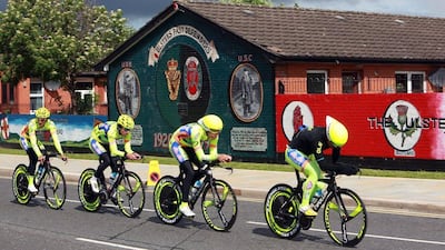Riders of Neri Sottoli team cycle past pro-British Loyalist murals in Belfast during the first stage of the 2014 Giro d'Italia on Friday. Paul McErlane / EPA