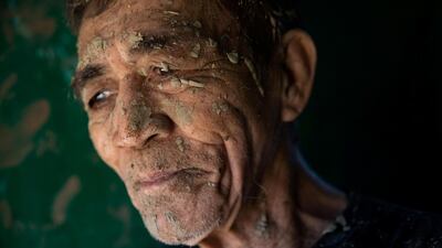 A man takes a break from cleaning his house, which was covered in mud after flooding caused by Typhoon Vamco, in San Mateo, Rizal province, Philippines. Reuters