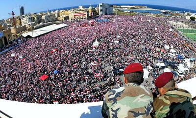 Lebanese soldiers keep an eye on hundreds of thousands of demonstrators gathered at Martyrs Square in Beirut on March 14, 2005. AFP