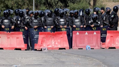 Iraqi security forces look on as protesters try to approach a bridge leading to the Green Zone, where the US embassy is located, in Baghdad. AFP