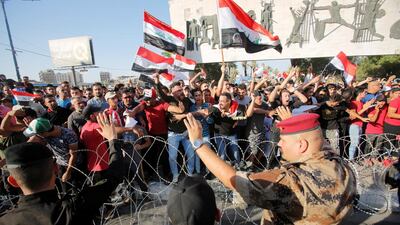 Protesters dispersed by riot police during the protests in Baghdad. Reuters