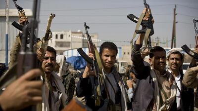 Houthi fighters hold their weapons during clashes near the presidential palace in Sanaa on January 19. Rebel Hani Mohammed / AP Photo