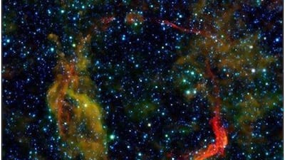 Infrared images from Nasa's Spitzer Space Telescope and the Wide-field Infrared Survey Explorer were combined in this image of RCW 86, the dusty remains of the oldest documented example of a supernova. AFP Photo / Nasa