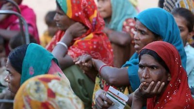 Dafer tribeswomen at Vijapur village in the Gujarat state hold their new ID cards issued by the Indian government.