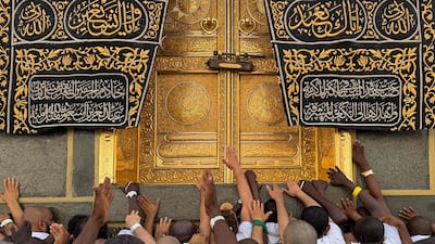 Muslim worshippers touch the Kaaba, Islam's holiest shrine. AFP