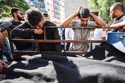 Palestinians mourn victims of an Israeli air strike that targeted a vehicle in Gaza. AFP